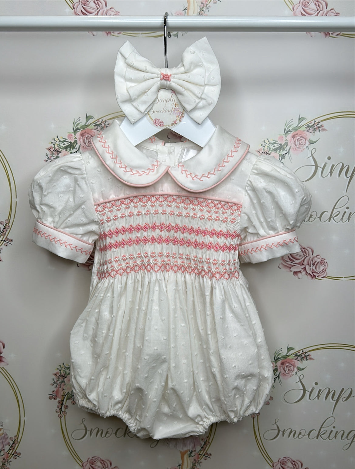 Hand smocked pink and white swiss dot romper